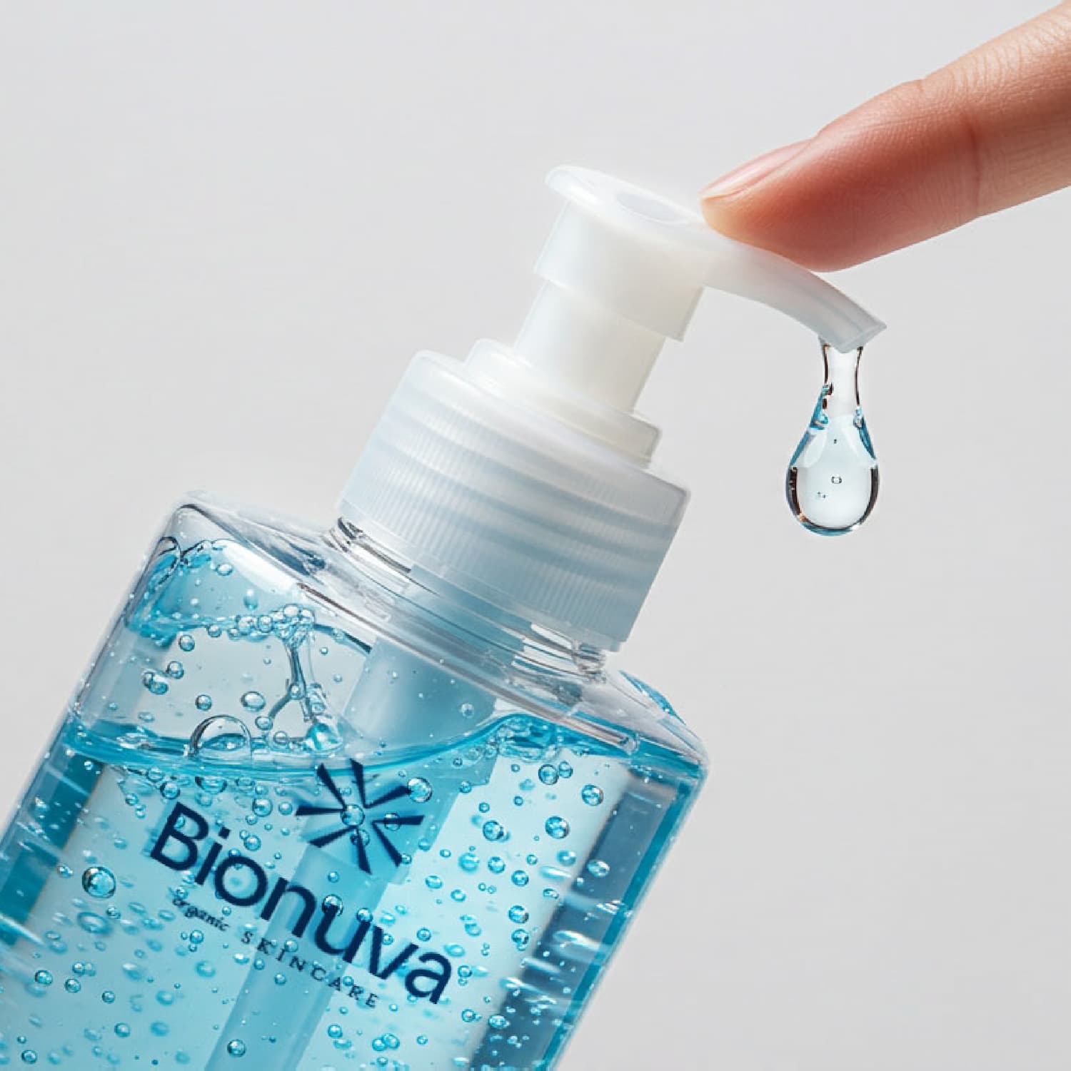 Close-up product photography for Bionuva Blue Probiotic Cleanser pump with a drop of gel. Designed byannas.com.